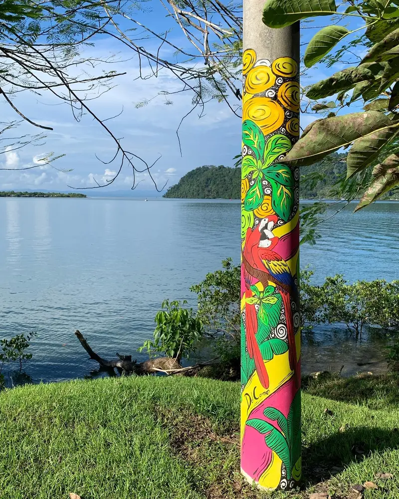 Community art on the Golfito waterfront, with the bay behind